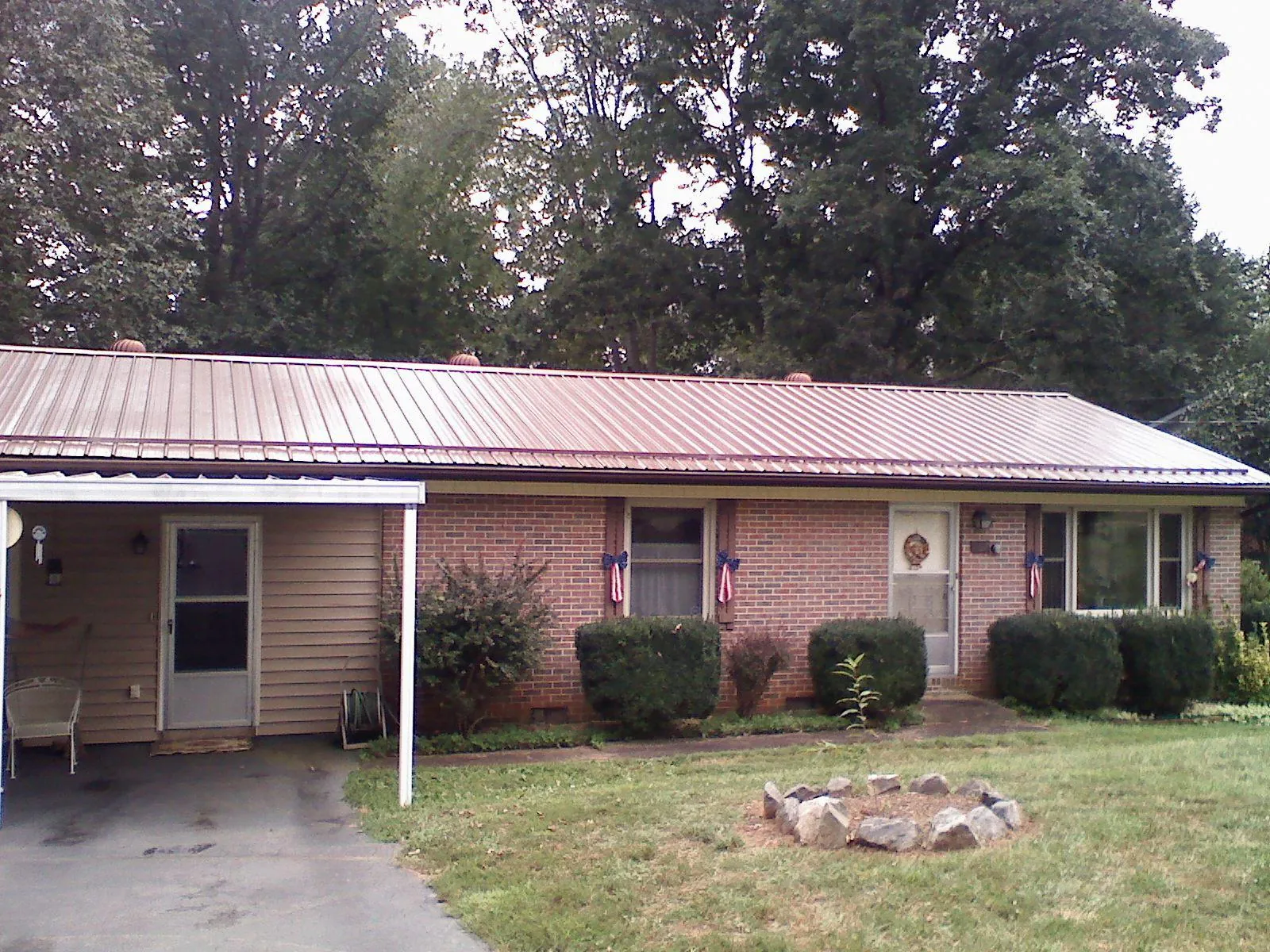 Bronze metal roof and carport on a brick ranch home — Roof Repair work by our crew in Scituate